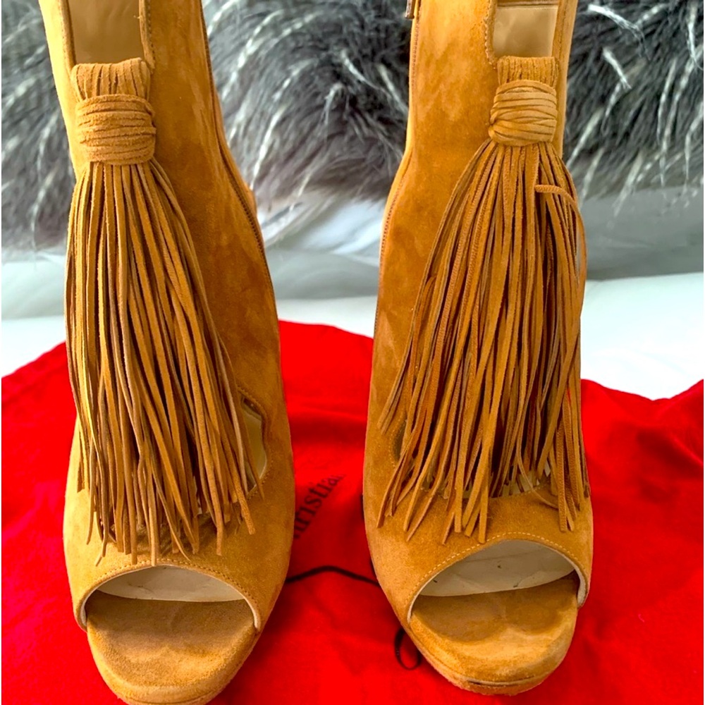 Gently used Christian Louboutin Otoka 120 peep-toe booties with fringe accent